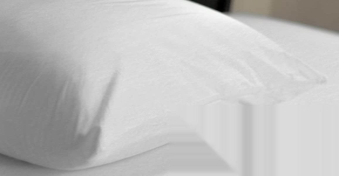 Zippered Pillow Protector on a made bed